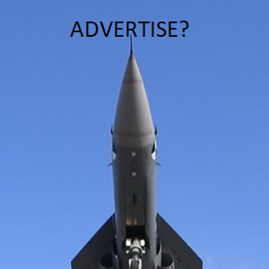 A close-up view of the nose of a missile pointing upwards against a blue sky, with the word 'ADVERTISE?' overlayed above it.